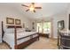Comfortable main bedroom with a four-poster bed, ceiling fan, and natural light at 672 Ashley Manor Dr., Longs, SC 29568