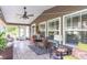 Cozy screened porch with comfortable seating, tiled floor, and ample natural light at 672 Ashley Manor Dr., Longs, SC 29568