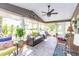 Cozy sunroom with tiled floor, large windows, comfortable seating, and a ceiling fan at 672 Ashley Manor Dr., Longs, SC 29568