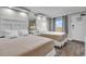 A guest bedroom is furnished with two double beds, modern decor, and updated lighting at 6900 N Ocean Blvd. # 1437, Myrtle Beach, SC 29572