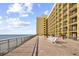 Oceanfront building with an expansive outdoor patio and lounge area at 6900 N Ocean Blvd. # 1437, Myrtle Beach, SC 29572