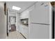 A compact kitchen has white cabinets, modern appliances, and tiled flooring at 6900 N Ocean Blvd. # 1437, Myrtle Beach, SC 29572