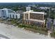 Stunning aerial view of beachfront condos featuring balconies and ocean access in a vibrant coastal community at 6900 N Ocean Blvd. # 710, Myrtle Beach, SC 29572
