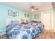 Comfortable bedroom with two beds, ceiling fan, and beach-themed decor at 6900 N Ocean Blvd. # 710, Myrtle Beach, SC 29572