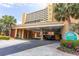 View of the building entrance with covered parking and well-maintained landscaping at 6900 N Ocean Blvd. # 710, Myrtle Beach, SC 29572