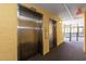 Elevators in the hallway with the pool visible through the gate at 6900 N Ocean Blvd. # 710, Myrtle Beach, SC 29572