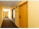 A view of a hallway with doors on either side and an exit sign visible at the end at 6900 N Ocean Blvd. # 710, Myrtle Beach, SC 29572