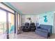 Cozy living room featuring stylish seating, a coastal theme, and balcony access at 6900 N Ocean Blvd. # 710, Myrtle Beach, SC 29572