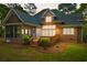 Backyard of home with a screened porch, deck, and neatly mulched flower beds, ideal for outdoor enjoyment at 79 Windsor Circle Sw, Ocean Isle Beach, NC 28469