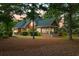 Home exterior showcasing screened porch and deck surrounded by lush landscaping, offering a private outdoor retreat at 79 Windsor Circle Sw, Ocean Isle Beach, NC 28469