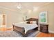 Inviting bedroom featuring a ceiling fan, warm lighting, and a decorative rug at 79 Windsor Circle Sw, Ocean Isle Beach, NC 28469