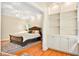 Bedroom with built-in shelving and bed with dark wood frame at 79 Windsor Circle Sw, Ocean Isle Beach, NC 28469