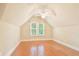 Bright bedroom featuring sloped ceilings, hardwood floors, and a ceiling fan at 79 Windsor Circle Sw, Ocean Isle Beach, NC 28469