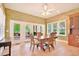 Cozy dining area featuring a ceiling fan and glass doors to an outdoor patio at 79 Windsor Circle Sw, Ocean Isle Beach, NC 28469