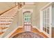 Spacious foyer features hardwood floors, a staircase, and an open layout leading into the main living areas at 79 Windsor Circle Sw, Ocean Isle Beach, NC 28469