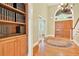 Elegant foyer with hardwood floors, staircase, built-in bookcase, and a double door entrance for a grand welcome at 79 Windsor Circle Sw, Ocean Isle Beach, NC 28469