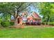 Well-maintained brick home with lush green lawn, mature trees, and symmetrical landscaping for great curb appeal at 79 Windsor Circle Sw, Ocean Isle Beach, NC 28469