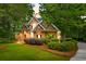 Brick home featuring manicured landscaping, healthy lawn, and a symmetrical facade offering great curb appeal at 79 Windsor Circle Sw, Ocean Isle Beach, NC 28469