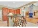 The kitchen bar overlooks the living room with stone fireplace and built-in shelving at 79 Windsor Circle Sw, Ocean Isle Beach, NC 28469