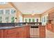 This kitchen features dark granite countertops, stainless steel appliances, and wood cabinets at 79 Windsor Circle Sw, Ocean Isle Beach, NC 28469