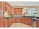 A kitchen with tile flooring, wood cabinets, and dark countertops at 79 Windsor Circle Sw, Ocean Isle Beach, NC 28469