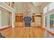 Open living room boasts a stone fireplace, built-in shelving, and bright windows at 79 Windsor Circle Sw, Ocean Isle Beach, NC 28469