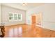 Bright living room with hardwood floors, large window offering natural light, and double doors to the hallway at 79 Windsor Circle Sw, Ocean Isle Beach, NC 28469