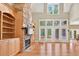 Spacious living room featuring a stone fireplace and light wood built-in shelving at 79 Windsor Circle Sw, Ocean Isle Beach, NC 28469