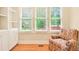 Comfortable sitting area with built-in shelving, chair, and natural light from three windows at 79 Windsor Circle Sw, Ocean Isle Beach, NC 28469