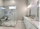 Modern bathroom featuring a glass-enclosed shower and double vanity with marble countertops at 80 Landing Dr. # 80, Pawleys Island, SC 29585