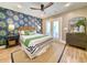 Bright bedroom with a blue and green accent wall, a bed with stylish linens, and natural light at 80 Landing Dr. # 80, Pawleys Island, SC 29585