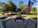 View from porch, showcasing the landscaped driveway and the lovely tree-lined street beyond the property at 80 Landing Dr. # 80, Pawleys Island, SC 29585