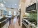 Gourmet kitchen with stainless steel appliances, a large island sink, and an open view to the living room at 80 Landing Dr. # 80, Pawleys Island, SC 29585
