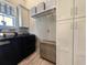 Functional laundry room equipped with black washer and dryer, storage cabinets, and wicker hamper at 80 Landing Dr. # 80, Pawleys Island, SC 29585