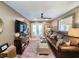 Inviting living room with a brown leather sofa, decorative rug, and access to the outdoor patio at 80 Landing Dr. # 80, Pawleys Island, SC 29585