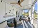 Inviting porch with cozy seating, overhead fan, and glimpses of the lovely outdoor space and greenery at 80 Landing Dr. # 80, Pawleys Island, SC 29585