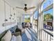 Relaxing screened-in porch featuring comfortable seating, ceiling fan, and views of the beautifully landscaped yard at 80 Landing Dr. # 80, Pawleys Island, SC 29585