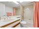 Bright bathroom with a single sink vanity, tiled shower and tub, and skylight at 931 Cedarwood Circle, Myrtle Beach, SC 29572