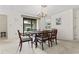 Open dining area with chandelier, adjacent to a sliding glass door and living spaces at 931 Cedarwood Circle, Myrtle Beach, SC 29572