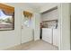 Convenient laundry room with washer, dryer, storage cabinets, and a window for natural light at 931 Cedarwood Circle, Myrtle Beach, SC 29572