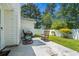 Spacious backyard featuring a patio with rocking chairs, well-maintained lawn, and privacy fencing at 9607 Kings Grant Dr., Murrells Inlet, SC 29576