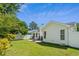 Expansive backyard view with a patio, rocking chairs, and a well-manicured lawn, ideal for outdoor relaxation at 9607 Kings Grant Dr., Murrells Inlet, SC 29576