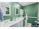 Bathroom with double vanity, framed mirrors, and ample storage space for toiletries and linens at 9607 Kings Grant Dr., Murrells Inlet, SC 29576