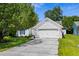 Charming home featuring an attached two-car garage, lush lawn, and mature tree at 9607 Kings Grant Dr., Murrells Inlet, SC 29576