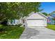 Charming home featuring an attached two-car garage, lush lawn, and mature tree at 9607 Kings Grant Dr., Murrells Inlet, SC 29576
