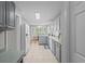Spacious kitchen boasts views into dining area, classic white appliances, and tile floors at 9607 Kings Grant Dr., Murrells Inlet, SC 29576