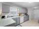 Well-lit kitchen with subway tile backsplash, stainless steel appliances, and light gray cabinetry at 9607 Kings Grant Dr., Murrells Inlet, SC 29576