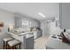 Charming kitchen features gray cabinetry, tiled flooring, and a functional breakfast bar with seating for two at 9607 Kings Grant Dr., Murrells Inlet, SC 29576