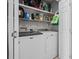 Functional laundry room with modern washer and dryer units and organized shelving for storage at 9607 Kings Grant Dr., Murrells Inlet, SC 29576