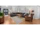 Comfortable living room features a sectional sofa, wood floors, and an area rug; plenty of space at 9607 Kings Grant Dr., Murrells Inlet, SC 29576